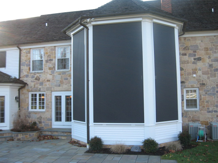 the backyard of a home with three large screens covering an entire bay window
